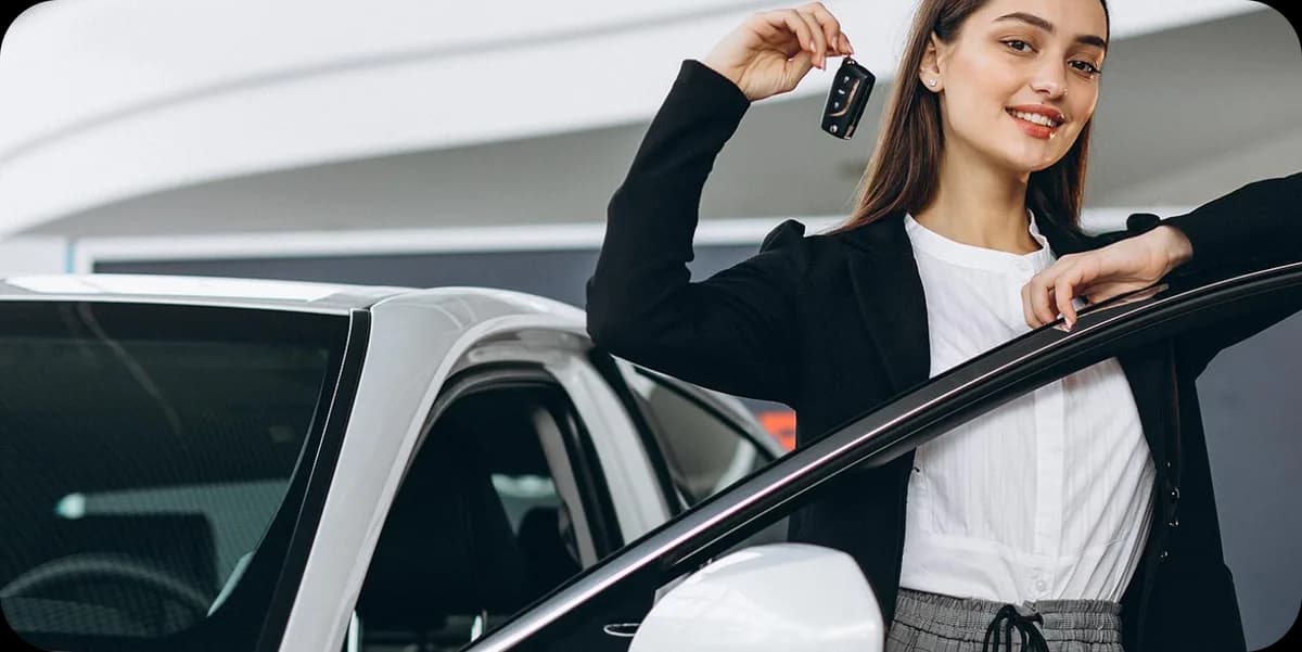 Bharat Car representative handing over keys beside a rental vehicle
